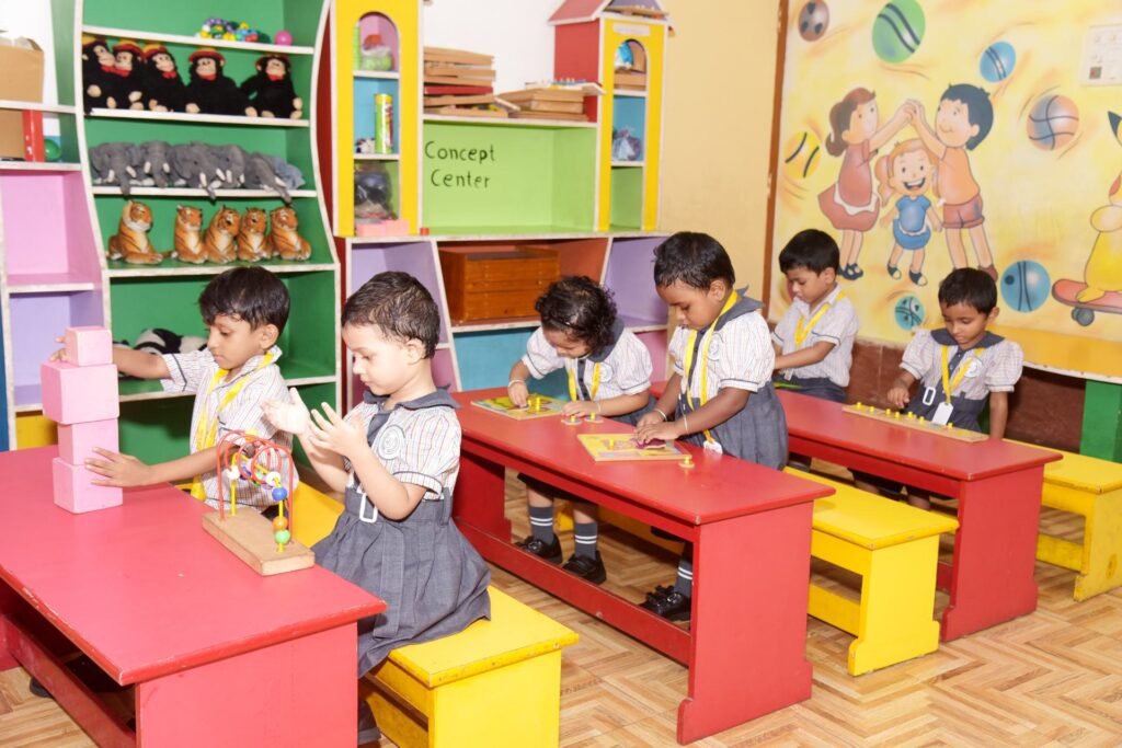 Nursery children playing with blocks and puzzles in the early-years activity room