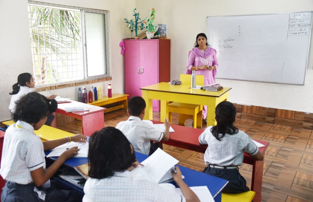 Teacher at her desk with a primary class at St. Xavier's Public School, Haldia
