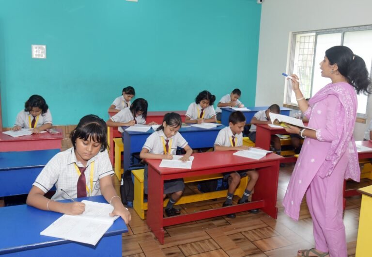Teacher with a book taking a primary class