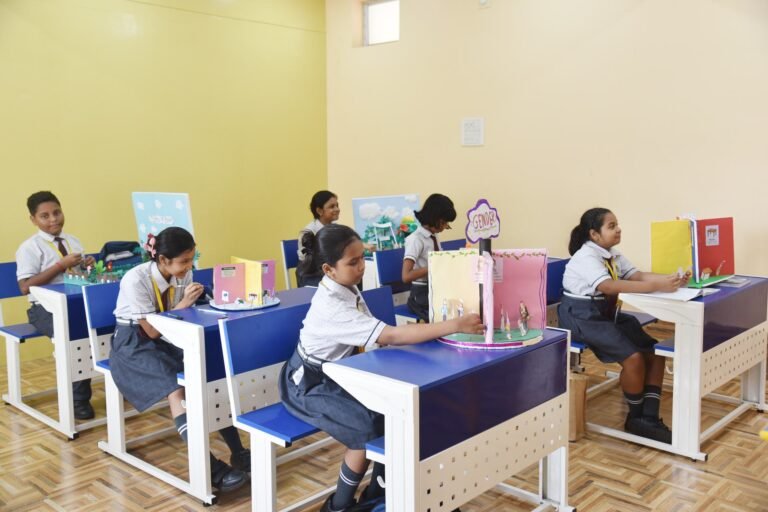 Pupils working on project models at their desks in a classroom