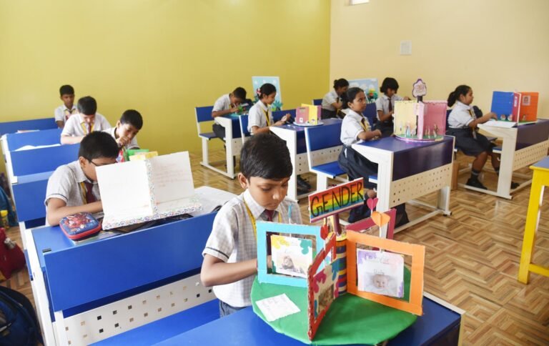 Pupil showing a handmade project model in class