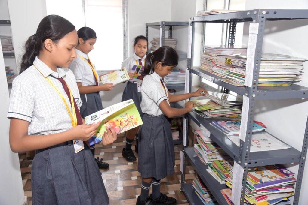 Pupils reading and choosing books in the school library