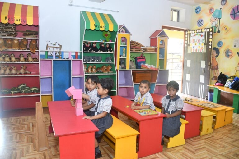 Nursery children at tables in the activity room