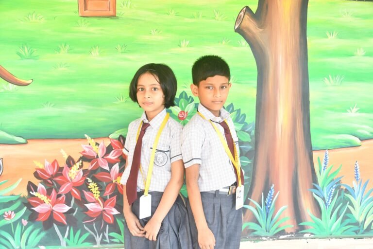 Two pupils standing back to back in front of a mural